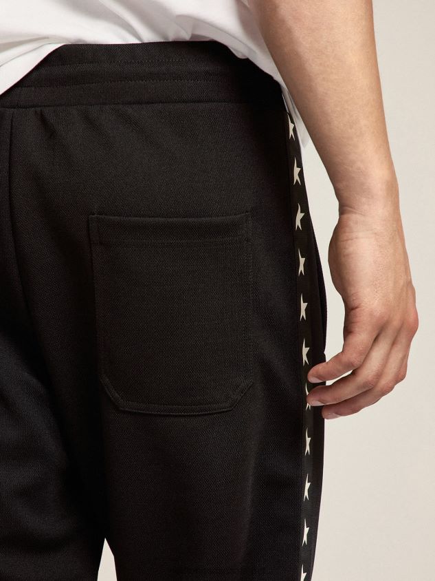 black joggers with white stars on the sides FN20N764 Men Golden Goose